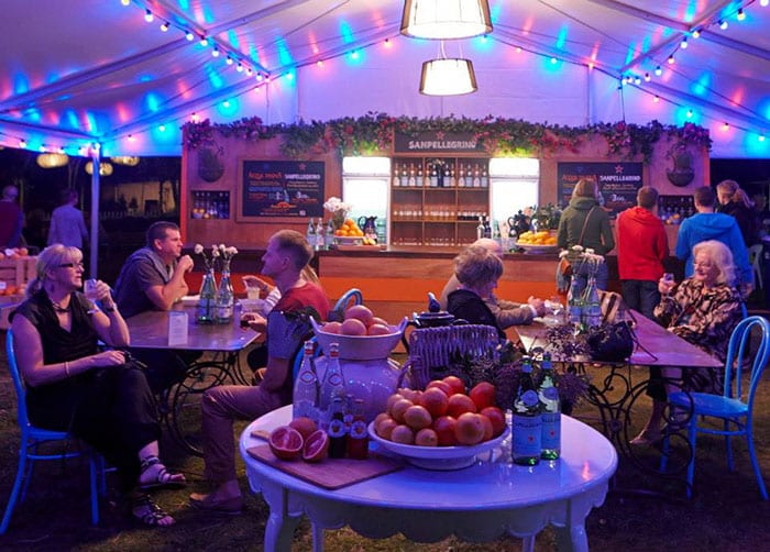 Lined marquee and pendant lighting in festival VIP marquee